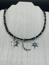 Load image into Gallery viewer, Whimsical Celestial Crescent Moon And Stars Collar Stye Adjustable Glass Beaded Necklace. Two strands are held together with double-hole black and silver beads to keep a collar shape. This necklace beautifully drapes across your neck, a fierce, bold and elegant piece of jewelry. Perfect for Goth, Witchy, and Stardust Celestial Styles.  Measurements:    Necklace is 15” in length (“collar” style), can be adjusted up to 18"