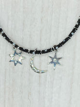 Load image into Gallery viewer, Whimsical Celestial Crescent Moon And Stars Collar Stye Adjustable Glass Beaded Necklace. Two strands are held together with double-hole black and silver beads to keep a collar shape. This necklace beautifully drapes across your neck, a fierce, bold and elegant piece of jewelry. Perfect for Goth, Witchy, and Stardust Celestial Styles.  Measurements:    Necklace is 15” in length (“collar” style), can be adjusted up to 18"