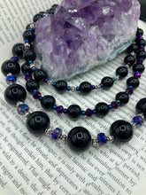 Load image into Gallery viewer, This stunning Shimmery black glass and floral metal beaded necklace features three long strands which gracefully drape around the neck. Its bold elegance is the perfect accessory for a cocktail chic outfit, a wedding, or a more minimalist look.  Measurements:    Necklace is 16 1/4” in length - adjustable to 18"