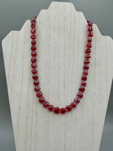 Load image into Gallery viewer, This ruby red heart-shaped glass beaded necklace features a shimmery and vivid iridescent hue, secured with a hook-eye clasp. Measurements:    Necklace is 19" in length