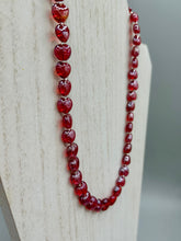 Load image into Gallery viewer, This ruby red heart-shaped glass beaded necklace features a shimmery and vivid iridescent hue, secured with a hook-eye clasp. Measurements:    Necklace is 19" in length