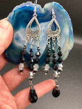 Load image into Gallery viewer, This stylish three-strand black and silver glass beaded earring design presents a beautiful dancing effect, boasting a large black teardrop glass bead. A versatile accessory, it suits a variety of ensembles from cocktail chic to wedding fineries, and its minimalist aesthetic lends a modern charm.  Measurements: 3 3/4” in length
