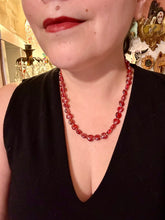Load image into Gallery viewer, This ruby red heart-shaped glass beaded necklace features a shimmery and vivid iridescent hue, secured with a hook-eye clasp. Measurements:    Necklace is 19" in length
