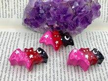 Load image into Gallery viewer, Cute and spooky magnet design to adorn your refrigerator, lockers, workstation, toolbox, or dishwasher. This hand-sculpted clay bat statuette boasts stunning ombre coloration, transitioning from black to dark red to pink to recreate the breathtaking look of a starry night sky. H 1” x W 2” x D 1/2”