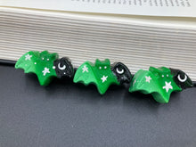 Load image into Gallery viewer, Cute and spooky magnet design to adorn your refrigerator, lockers, workstation, toolbox, or dishwasher. This hand-sculpted clay bat statuette boasts stunning ombre coloration, transitioning from black to dark green to light green to recreate the breathtaking look of a starry night sky.  H 1” x W 2” x D 1/2”