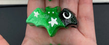 Load image into Gallery viewer, Cute and spooky magnet design to adorn your refrigerator, lockers, workstation, toolbox, or dishwasher. This hand-sculpted clay bat statuette boasts stunning ombre coloration, transitioning from black to dark green to light green to recreate the breathtaking look of a starry night sky. H 1” x W 2” x D 1/2”