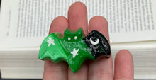 Load image into Gallery viewer, Cute and spooky magnet design to adorn your refrigerator, lockers, workstation, toolbox, or dishwasher. This hand-sculpted clay bat statuette boasts stunning ombre coloration, transitioning from black to dark green to light green to recreate the breathtaking look of a starry night sky. H 1” x W 2” x D 1/2”