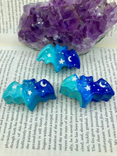 Load image into Gallery viewer, Cute and spooky magnet design to adorn your refrigerator, lockers, workstation, toolbox, or dishwasher. This hand-sculpted clay bat statuette boasts stunning ombre coloration, transitioning from dark blue to light blue to recreate the breathtaking look of a starry night sky. H 1” x W 2” x D 1/2”