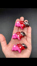 Load image into Gallery viewer, Cute and spooky magnet design to adorn your refrigerator, lockers, workstation, toolbox, or dishwasher. This hand-sculpted clay bat statuette boasts stunning ombre coloration, transitioning from black to dark red to pink to recreate the breathtaking look of a starry night sky. H 1” x W 2” x D 1/2”