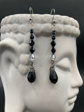 Load image into Gallery viewer, These shimmering black and silver glass beaded earrings feature a large black teardrop glass bead for added movement. This sophisticated and versatile accessory can be worn for an elegant evening look, brunch ensemble, wedding necklace, or minimalist style. Measurements: 2 1/2” in length