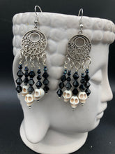 Load image into Gallery viewer, These Gothic Skulls Black Glass Beaded Earrings are a chic fashion statement that can enhance any look. Show off your inner Chingona, Cabrona, Latina Chicana, Goth, Vampire Goth, Dark Witchy, La Bruja Style with a cascade of shimmery skulls. Both formal and informal occasions can be elevated with these stylish earrings.  Measurements: 2 3/4 ” in length