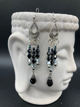 Load image into Gallery viewer, This stylish three-strand black and silver glass beaded earring design presents a beautiful dancing effect, boasting a large black teardrop glass bead. A versatile accessory, it suits a variety of ensembles from cocktail chic to wedding fineries, and its minimalist aesthetic lends a modern charm.  Measurements: 3 3/4” in length