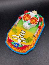 Load image into Gallery viewer, Transform your walls with this handcrafted polymer clay wall art. Showcasing a vibrant Frida Kahlo inspired calavera with hand-beaded floral crown, this Day of the Dead wall decor piece is perfect for adding a traditional Mexican folk art touch to any home.