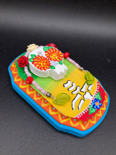 Load image into Gallery viewer, Transform your walls with this handcrafted polymer clay wall art. Showcasing a vibrant Frida Kahlo inspired calavera with hand-beaded floral crown, this Day of the Dead wall decor piece is perfect for adding a traditional Mexican folk art touch to any home.