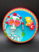 Load image into Gallery viewer, Transform your walls with this handcrafted polymer clay wall art. Showcasing a vibrant Frida Kahlo inspired calavera with hand-beaded floral crown, this Day of the Dead wall decor piece is perfect for adding a traditional Mexican folk art touch to any home.