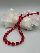 Load image into Gallery viewer, This ruby red heart-shaped glass beaded necklace features a shimmery, translucent finish and a lobster claw clasp. Measurements: Necklace is 18 1/2" in length