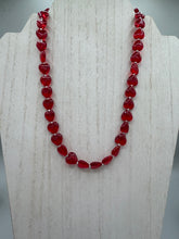 Load image into Gallery viewer, This ruby red heart-shaped glass beaded necklace features a shimmery, translucent finish and a lobster claw clasp. Measurements: Necklace is 18 1/2" in length