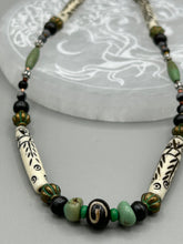 Load image into Gallery viewer, This exquisite necklace features natural ruby zoisite, snowflake obsidian, turquoise magnesite, bone, glass and metal beads, offering a variety of sizes, shapes, textures, and colors.