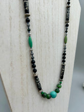 Load image into Gallery viewer, This necklace boasts a diverse selection of natural bead materials, including ruby zoisite, black and snowflake obsidian stones, plus turquoise magnesite, bone, glass and metal beads. This variety of sizes, shapes, textures and colors will make this necklace stand out. Measurements: Necklace - 23" in length