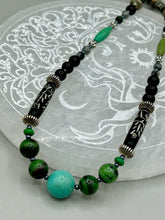 Load image into Gallery viewer, This necklace boasts a diverse selection of natural bead materials, including ruby zoisite, black and snowflake obsidian stones, plus turquoise magnesite, bone, glass and metal beads. This variety of sizes, shapes, textures and colors will make this necklace stand out. Measurements: Necklace - 23" in length