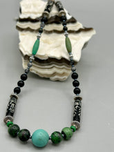 Load image into Gallery viewer, This necklace boasts a diverse selection of natural bead materials, including ruby zoisite, black and snowflake obsidian stones, plus turquoise magnesite, bone, glass and metal beads. This variety of sizes, shapes, textures and colors will make this necklace stand out. Measurements: Necklace - 23" in length