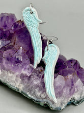 Load image into Gallery viewer, Light baby blue wings earrings made of polymer clay. These earrings are designed to face forward when worn instead of the front wings showing on the side.
