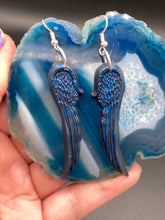 Load image into Gallery viewer, These eye-catching electric blue angel wings earrings are expertly crafted from polymer clay. Featuring an innovative design, they ensure the wings face forward when worn.