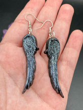 Load image into Gallery viewer, Chrome-colored silver angel wings earrings crafted with polymer clay. Featuring a construction designed to ensure the front wings face forward when worn.