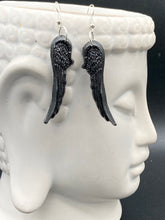 Load image into Gallery viewer, Shimmery black angel wings earrings made of polymer clay. These earrings are designed to face forward when worn instead of the front wings showing on the side.