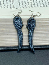 Load image into Gallery viewer, Chrome-colored silver angel wings earrings crafted with polymer clay. Featuring a construction designed to ensure the front wings face forward when worn.