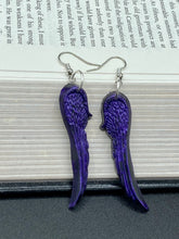 Load image into Gallery viewer, Sparkling dark purple angel wings earrings made of polymer clay.  These earrings are designed to face forward when worn instead of the front wings showing on the side.