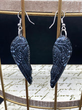 Load image into Gallery viewer, Chrome-colored silver angel wings earrings crafted with polymer clay. Featuring a construction designed to ensure the front wings face forward when worn.
