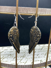Load image into Gallery viewer, Sparkling gold tone angel wings earrings made of polymer clay. These earrings are designed to face forward when worn instead of the front wings showing on the side.