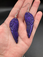 Load image into Gallery viewer, Sparkling dark purple angel wings earrings made of polymer clay.  These earrings are designed to face forward when worn instead of the front wings showing on the side.