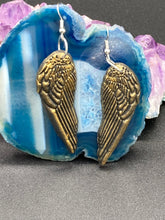 Load image into Gallery viewer, Sparkling gold tone angel wings earrings made of polymer clay. These earrings are designed to face forward when worn instead of the front wings showing on the side.