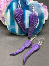 Load image into Gallery viewer, Sparkling dark purple angel wings earrings made of polymer clay.  These earrings are designed to face forward when worn instead of the front wings showing on the side.