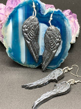 Load image into Gallery viewer, Chrome-colored silver angel wings earrings crafted with polymer clay. Featuring a construction designed to ensure the front wings face forward when worn.