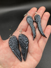 Load image into Gallery viewer, Chrome-colored silver angel wings earrings crafted with polymer clay. Featuring a construction designed to ensure the front wings face forward when worn.