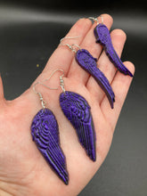 Load image into Gallery viewer, Sparkling dark purple angel wings earrings made of polymer clay.  These earrings are designed to face forward when worn instead of the front wings showing on the side.