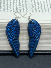 Load image into Gallery viewer, These eye-catching electric blue angel wings earrings are expertly crafted from polymer clay. Featuring an innovative design, they ensure the wings face forward when worn.
