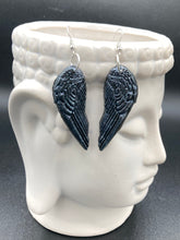 Load image into Gallery viewer, Chrome-colored silver angel wings earrings crafted with polymer clay. Featuring a construction designed to ensure the front wings face forward when worn.