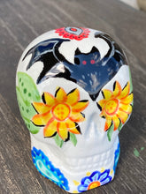 Load image into Gallery viewer, This Ceramic Skull Art With Bat Silhouettes And Flowers is a beautiful mini goth witchy altar skull, with detailed hand painted features. Inspired by the vibrant blooms of the Dawn Redwood, it captures the beauty of the changing of seasons. Perfect for adding a touch of whimsical enchantment to any home. Measurements: H 2 3/4” x W 2” x D 2”