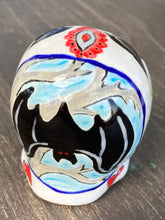 Load image into Gallery viewer, This Ceramic Skull Art With Bat Silhouettes And Flowers is a beautiful mini goth witchy altar skull, with detailed hand painted features. Inspired by the vibrant blooms of the Dawn Redwood, it captures the beauty of the changing of seasons. Perfect for adding a touch of whimsical enchantment to any home. Measurements: H 2 3/4” x W 2” x D 2”