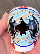 Load image into Gallery viewer, This Ceramic Skull Art With Bat Silhouettes And Flowers is a beautiful mini goth witchy altar skull, with detailed hand painted features. Inspired by the vibrant blooms of the Dawn Redwood, it captures the beauty of the changing of seasons. Perfect for adding a touch of whimsical enchantment to any home. Measurements: H 2 3/4” x W 2” x D 2”