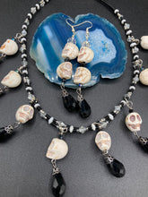Load image into Gallery viewer, Witchy Vibe, Goth Dark Souls Jewelry, Day Of The Dead, Dia De Los Muertos. Two large howlite skulls beaded earrings are accompanied by iridescent and black teardrop glass beads