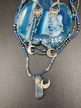 Load image into Gallery viewer, These three-strand chandelier style earrings offer an ornate and eye-catching look with their whimsical blue celestial charm accents adorned with smiling crescent moon designs. Perfect for creating a fairy princess, witchy, or boho aesthetic, they provide plenty of movement and can easily be added to any jewelry collection. Measurements: 3 1/2” in length