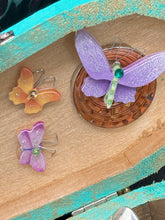 Load image into Gallery viewer, This Whimsical Fairy Wood Coffin Box is a truly unique and magical piece of home decor. With its vibrant turquoise exterior and eye-catching mini door knob, this Steampunk-inspired box is sure to be a conversation starter. Inside, the glittery gold interior and colorful butterfly detailing will bring a touch of fantasy to any room. The silver key and accompanying iridescent crystals complete the mystical and pastel goth look!