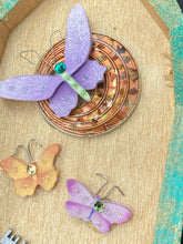 Load image into Gallery viewer, This Whimsical Fairy Wood Coffin Box is a truly unique and magical piece of home decor. With its vibrant turquoise exterior and eye-catching mini door knob, this Steampunk-inspired box is sure to be a conversation starter. Inside, the glittery gold interior and colorful butterfly detailing will bring a touch of fantasy to any room. The silver key and accompanying iridescent crystals complete the mystical and pastel goth look!