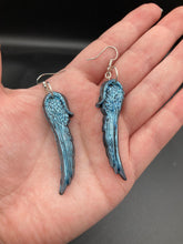 Load image into Gallery viewer, Sparkling light blue angel wings earrings made of polymer clay. These earrings are designed to face forward when worn instead of the front wings showing on the side.