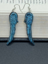 Load image into Gallery viewer, Sparkling light blue angel wings earrings made of polymer clay. These earrings are designed to face forward when worn instead of the front wings showing on the side.